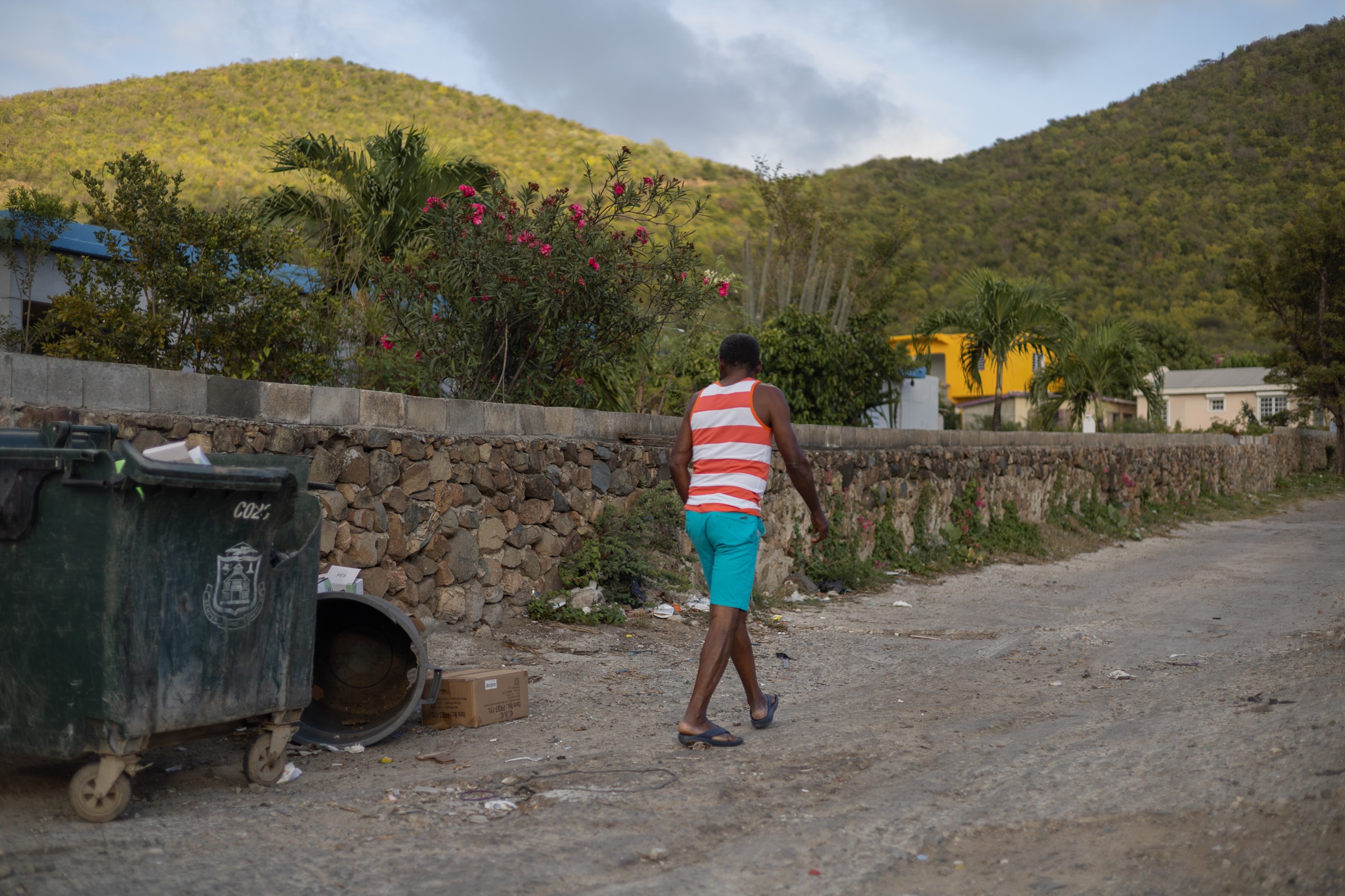 Man walking away across a rocky terrain in Saint-Martin