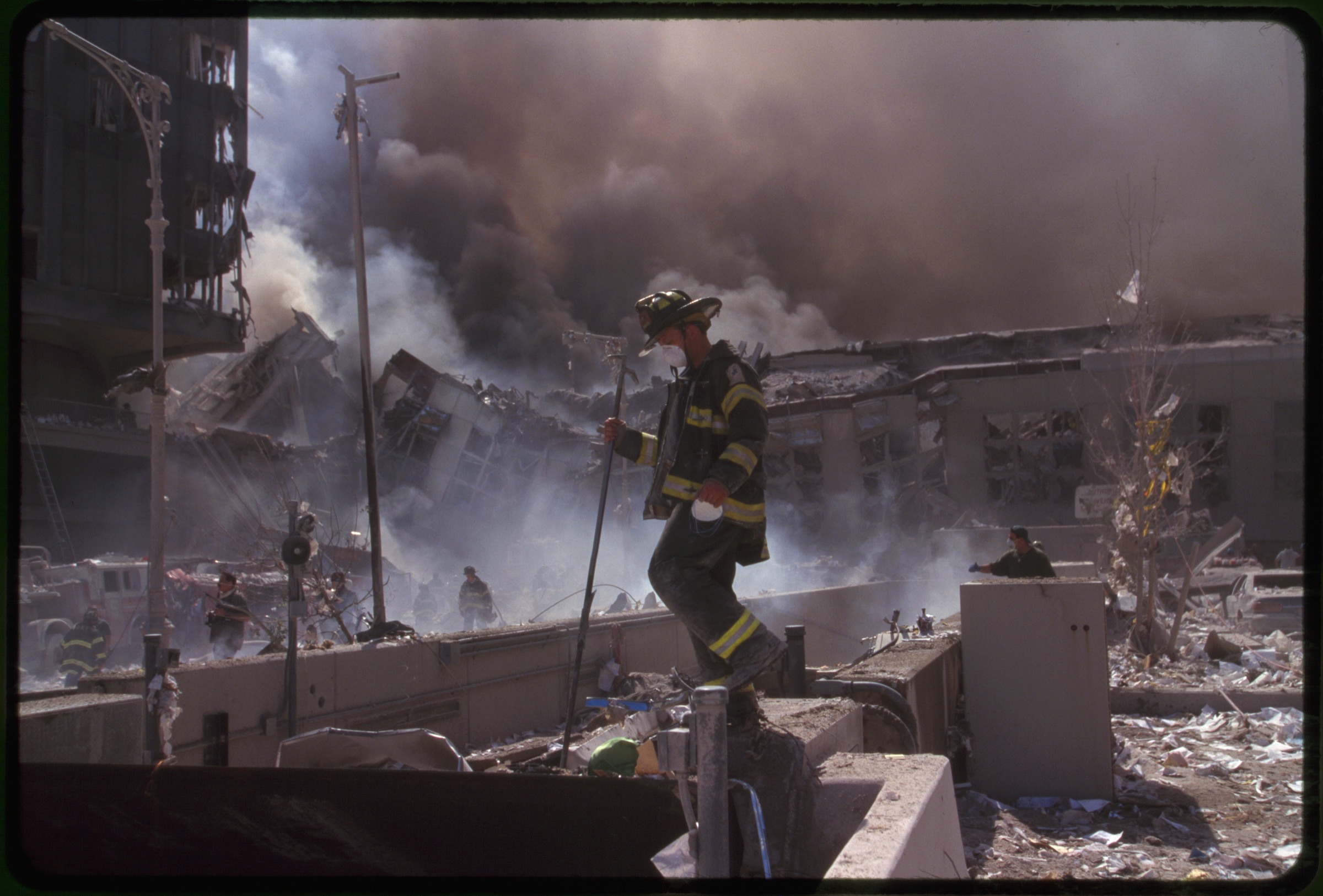 Fire fighters amid smoking rubble following September 11th terrorist attack on World Trade Center, New York City
