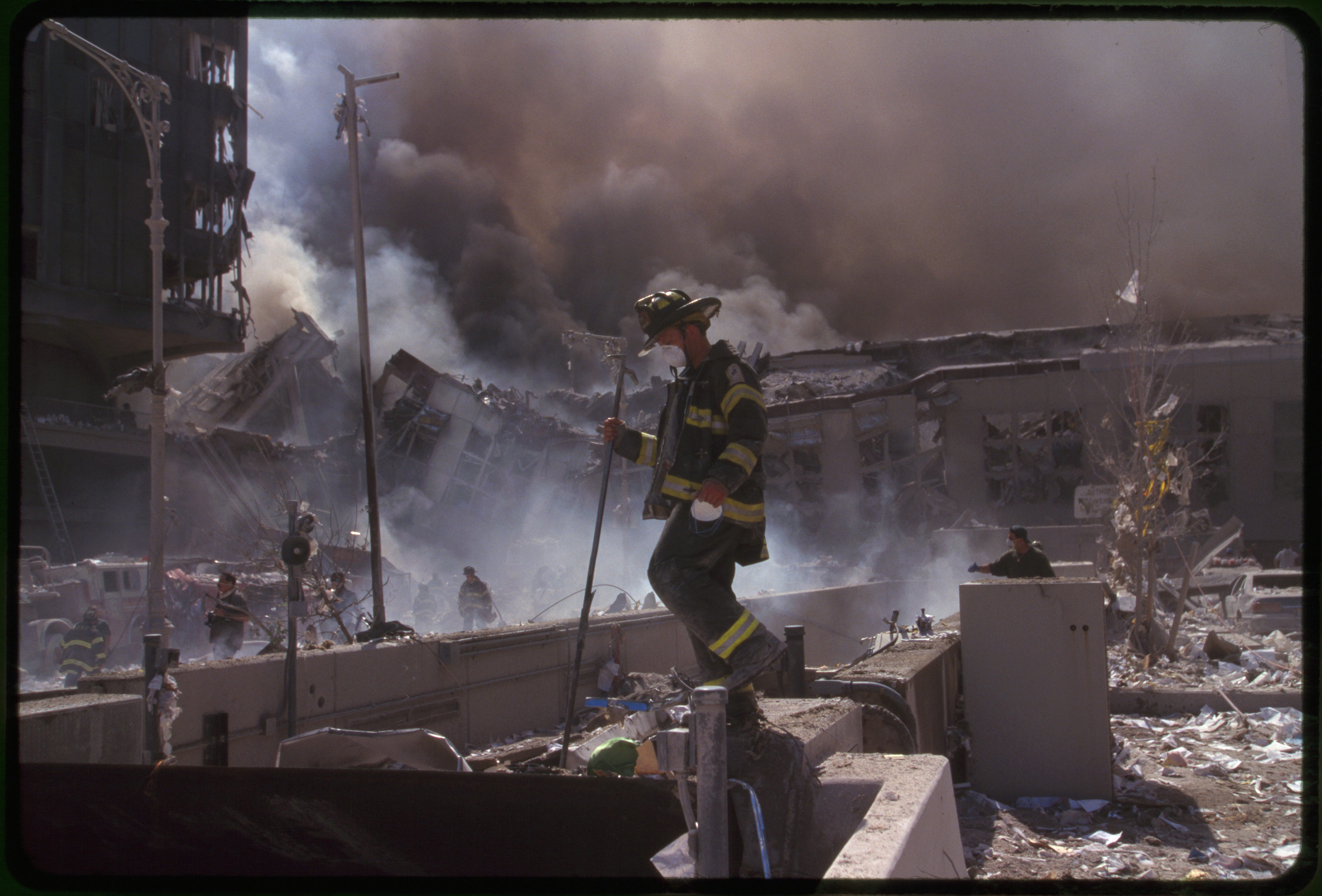 Fire fighters amid smoking rubble following September 11th terrorist attack on World Trade Center, New York City