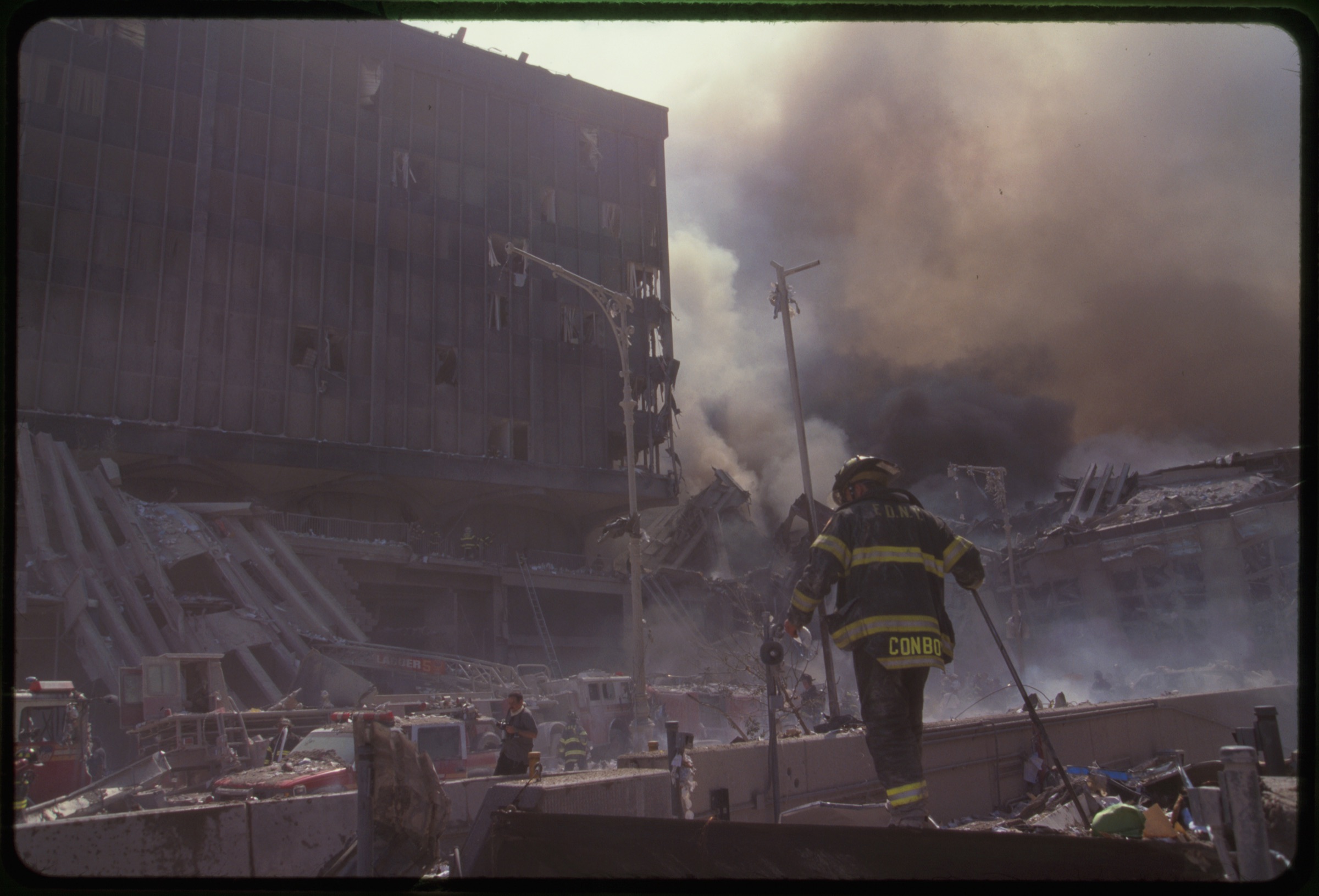 Fire fighters amid smoking rubble following September 11th terrorist attack on World Trade Center, New York City