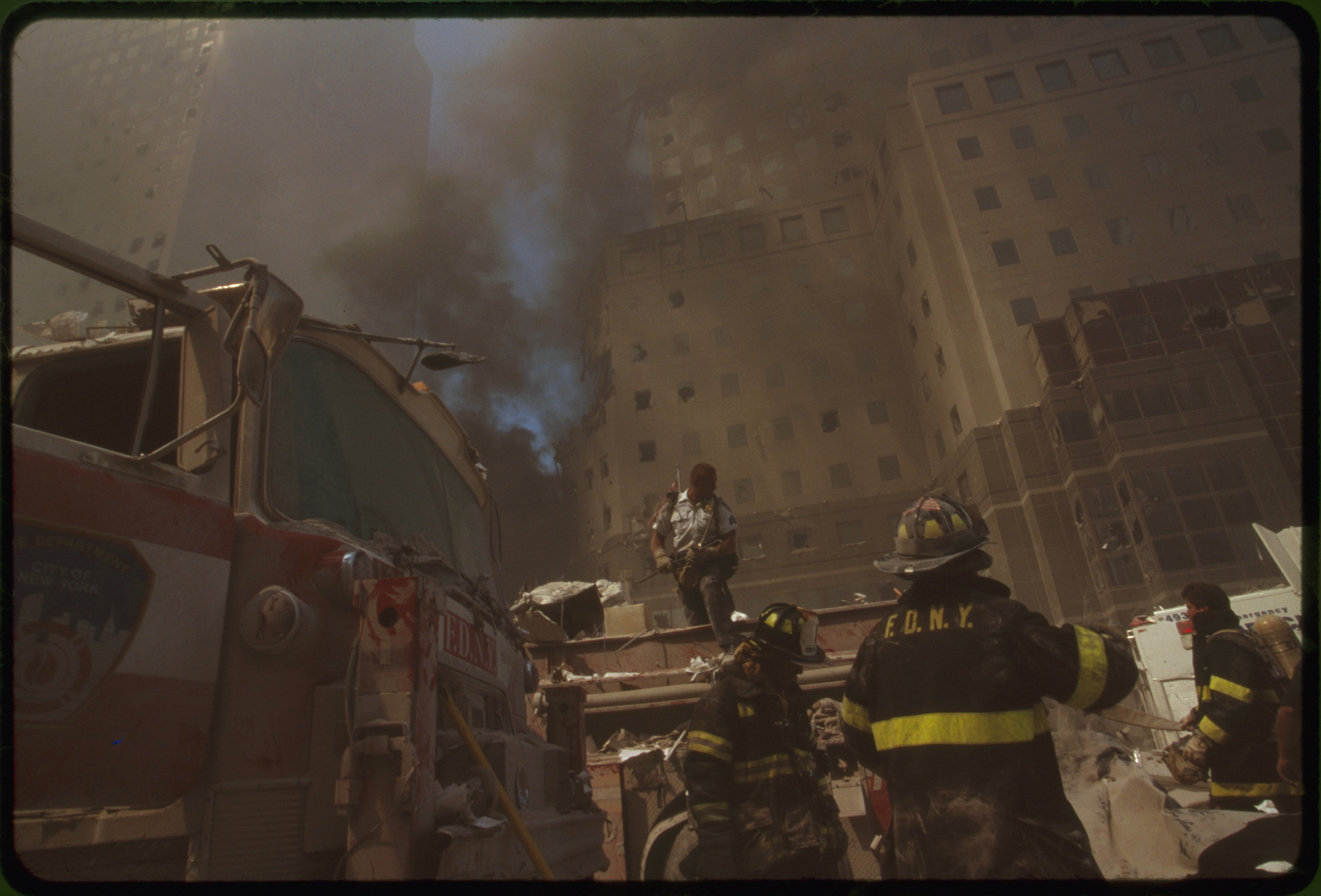 New York City fire fighters amid debris following September 11th terrorist attack on World Trade Center, New York City