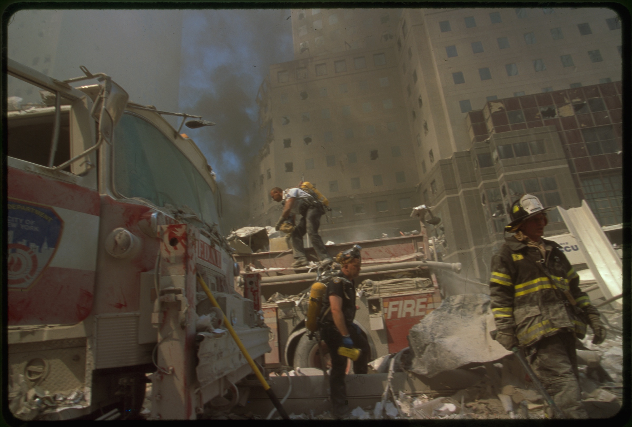 New York City fire fighters amid debris following September 11th terrorist attack on World Trade Center, New York City