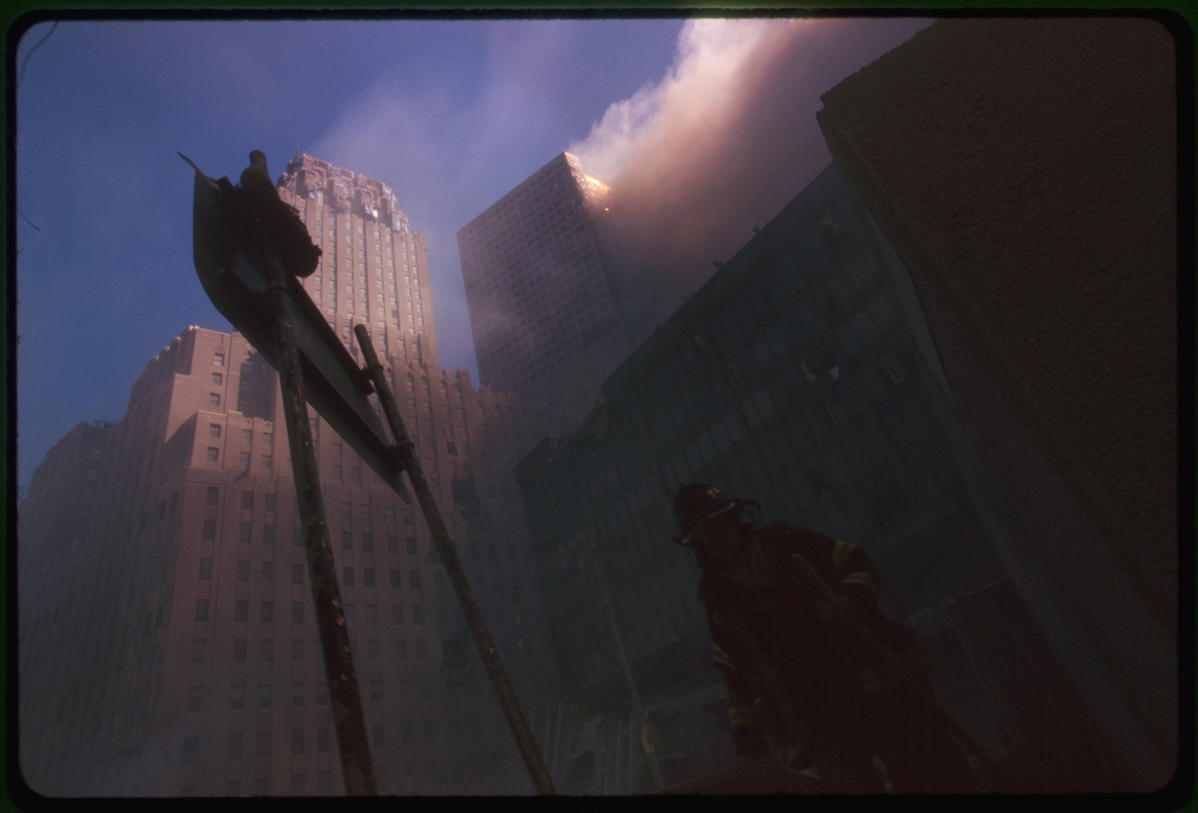 Fire fighter at base of burning building following September 11th terrorist attack on World Trade Center, New York City